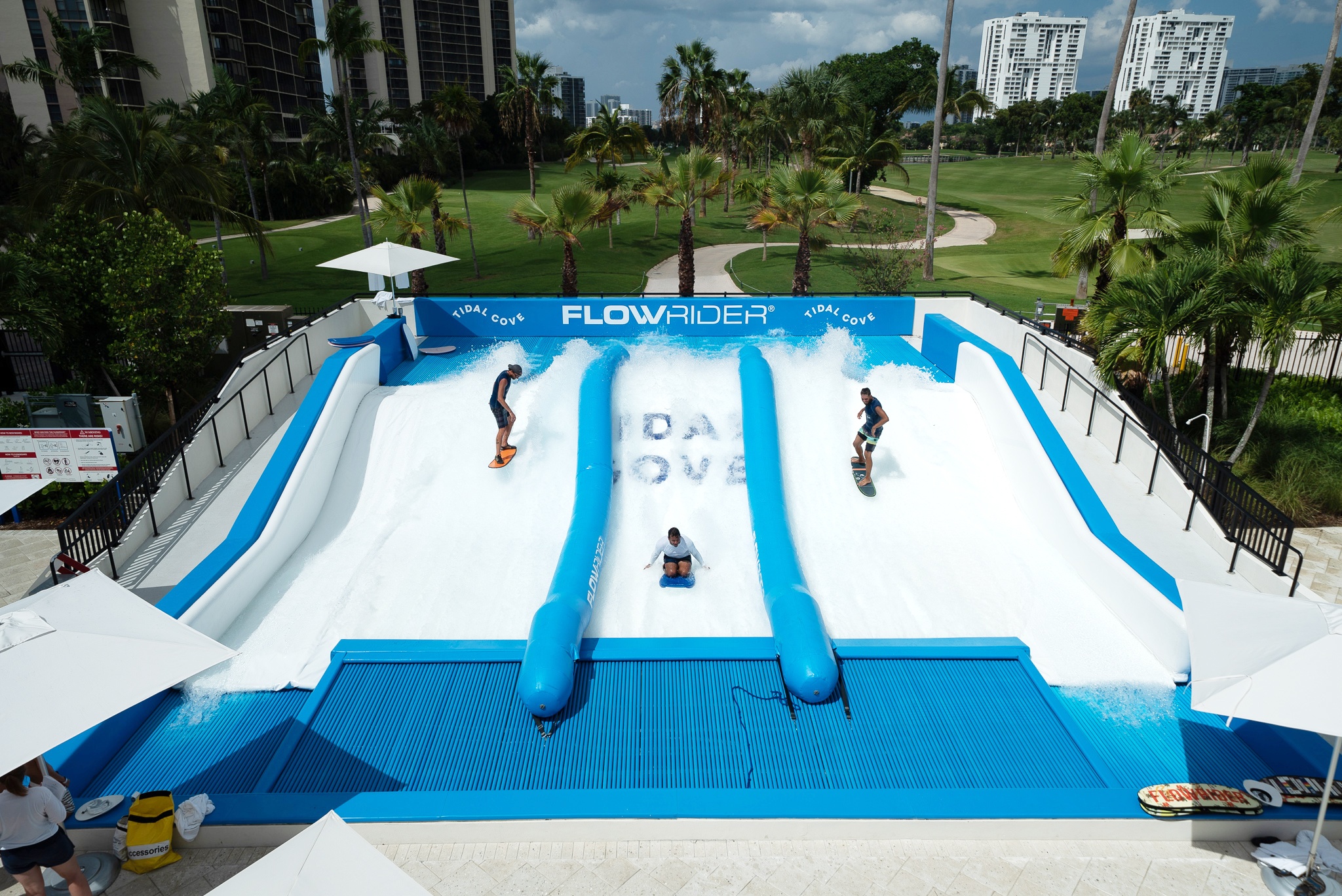 Three man are playing flowrider