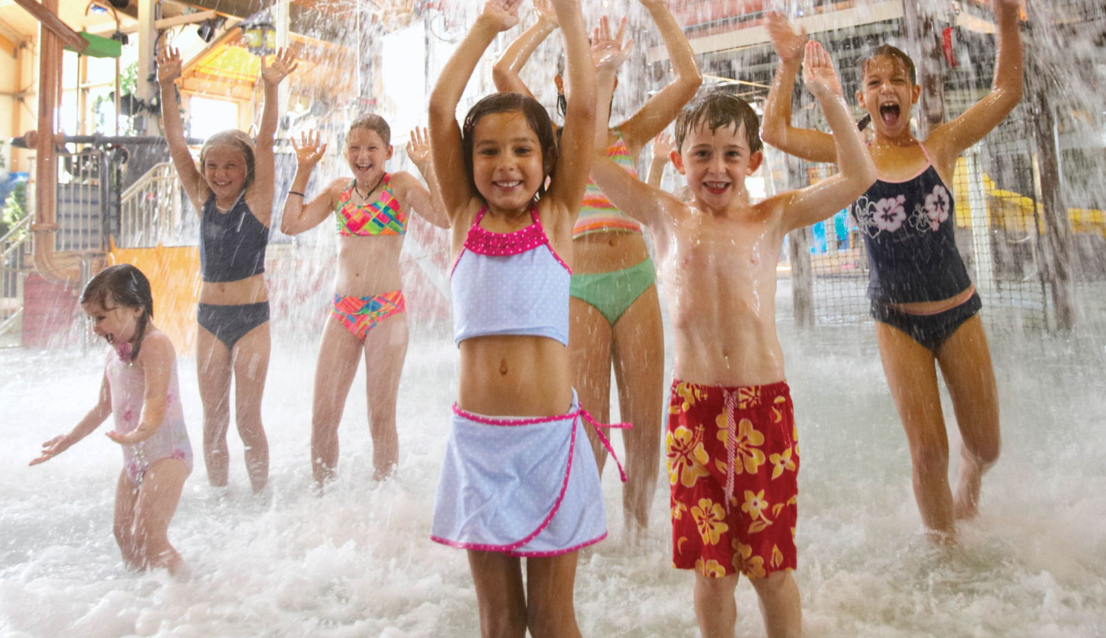Seven kids are enjoy the water falling down