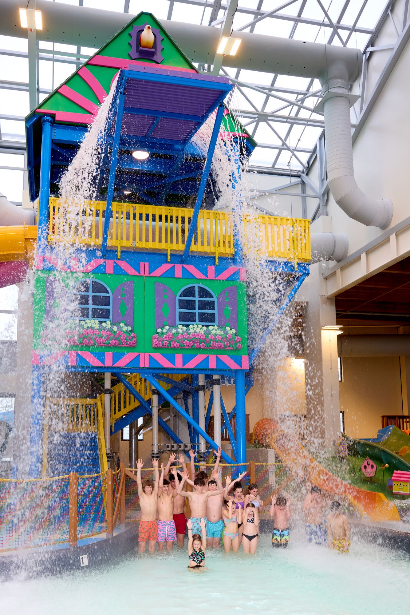 Water dumping on excited kids at an indoor water park
