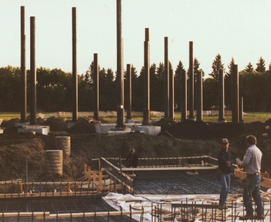 Three men working on a construction site to build the foundation