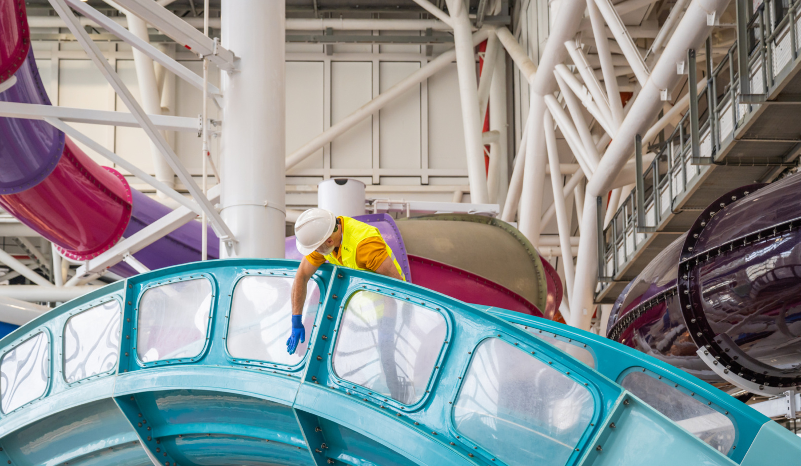 A man inspecting a water slide