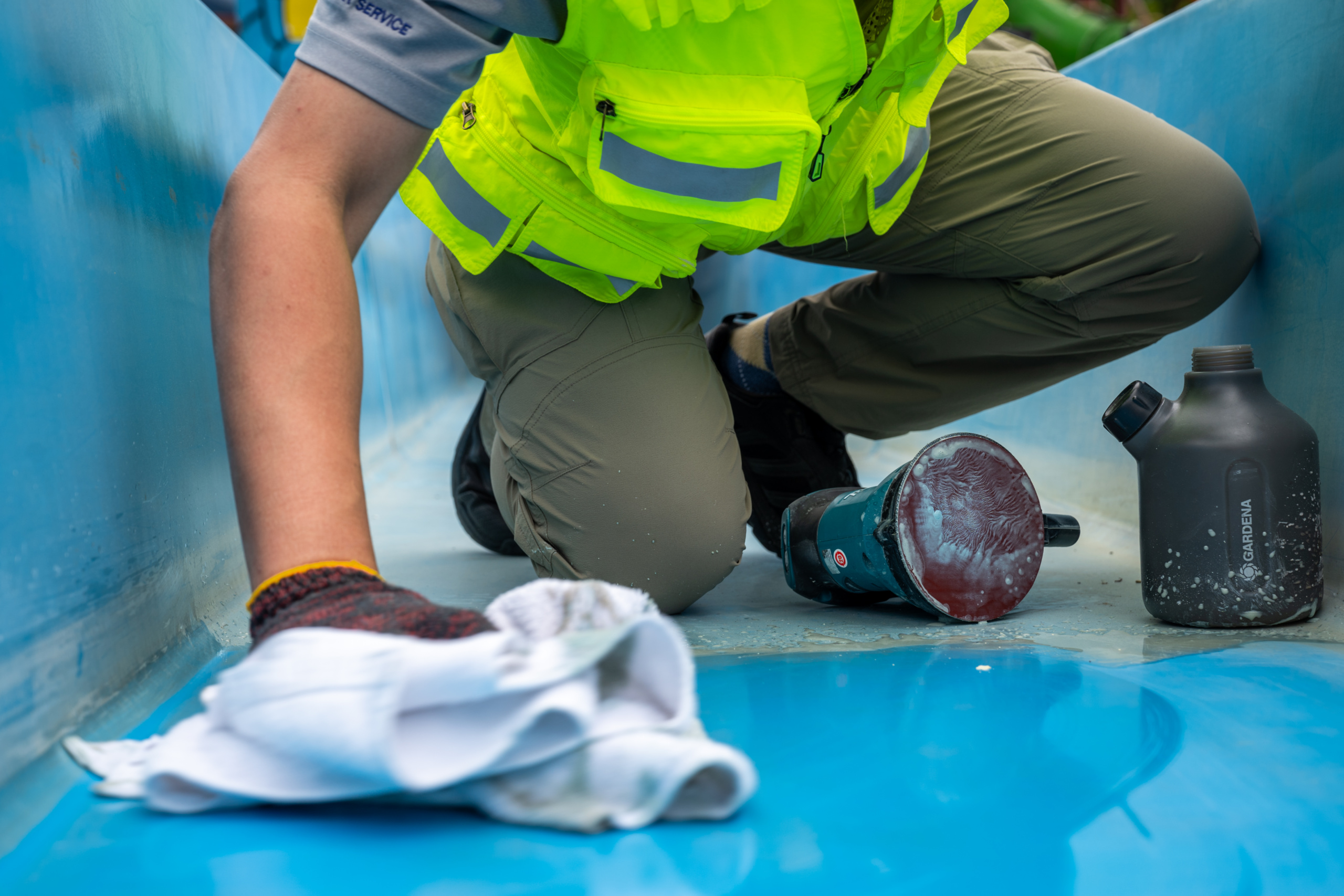 WhiteWater technician performing waterslide cleaning