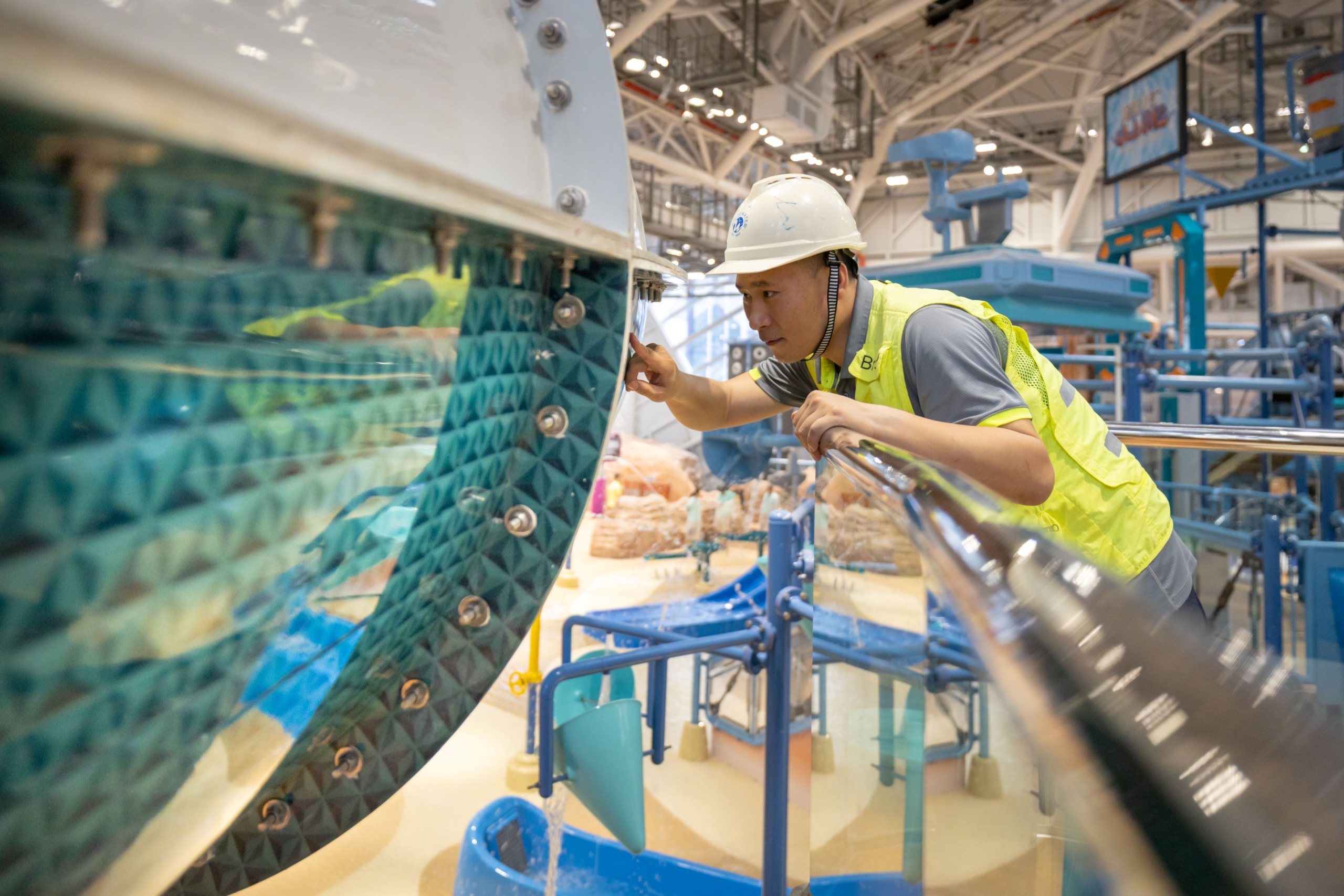 Man inspecting a water slide