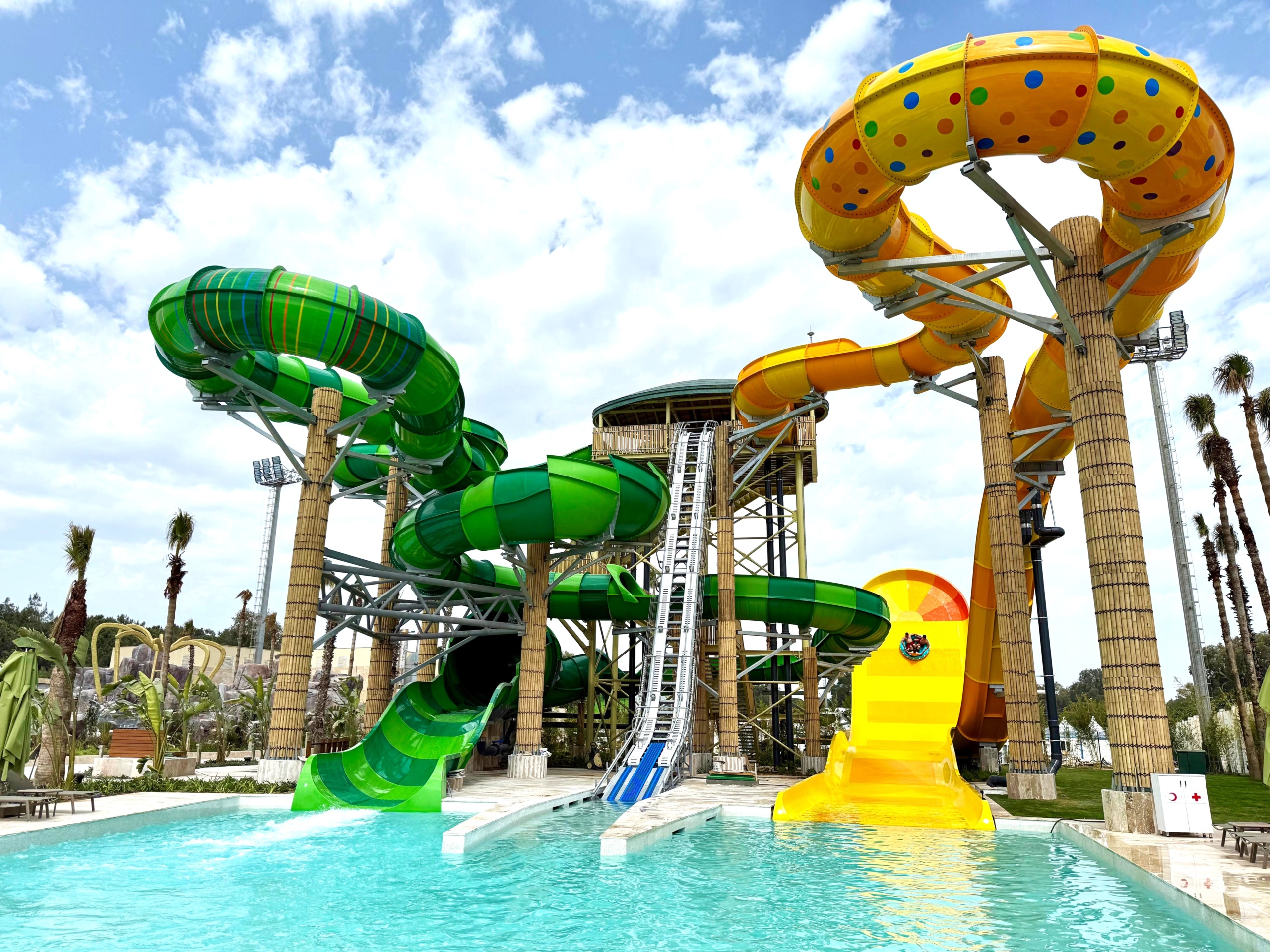 Colorful water slides with landing pool in the foreground