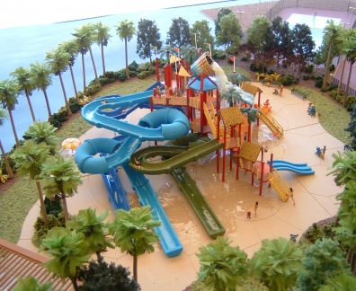 A bucket is pouring water down, and there are stairs for people to choose different slides.