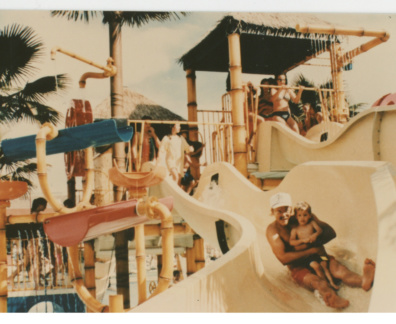 Early people playing on water slides