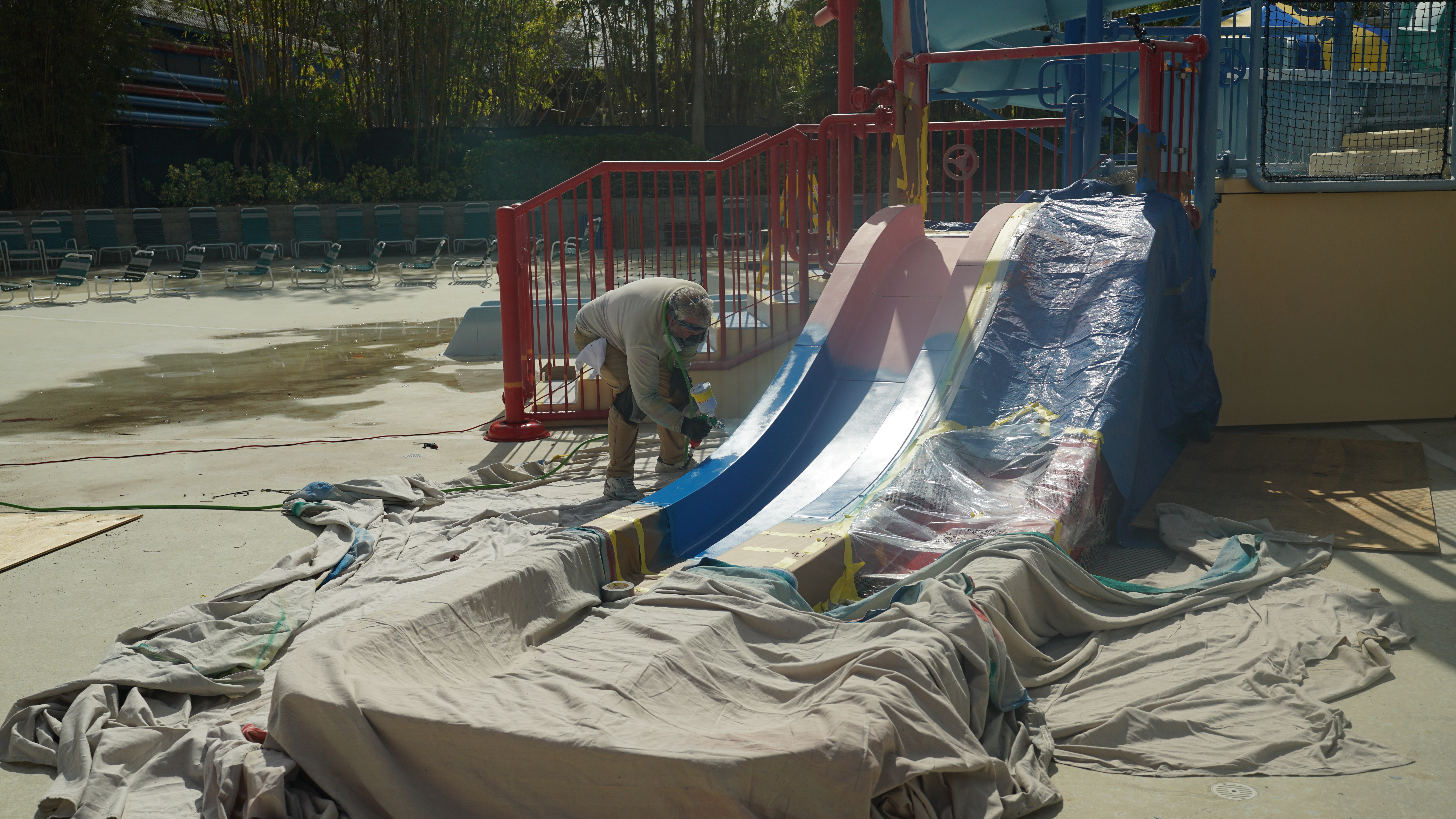 Man refurbishing a water slide